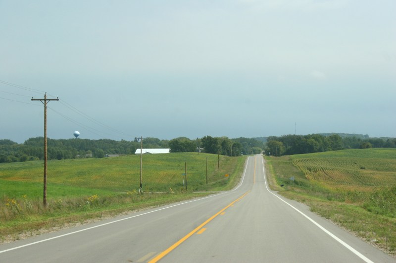 Fields line a back county road between Waterville and Elysian.