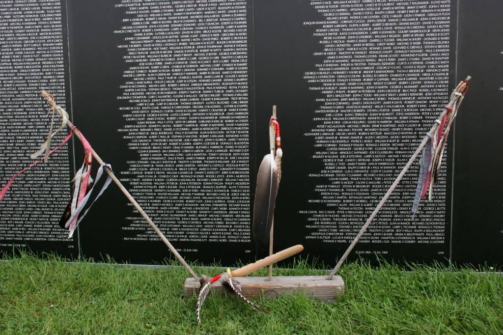 Ceremonial feathers and a peace pipe honor Blair Two Crow.