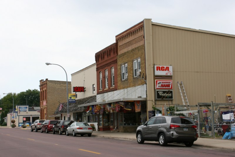 A snippet of Waterville's Main Street, including Ron's Hardware, jam-packed with merchandise.