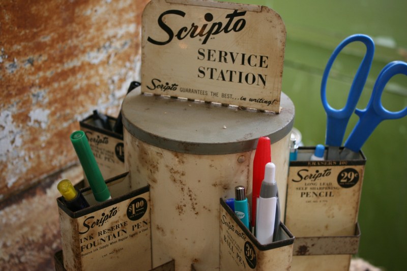 Sitting on the front counter, this Scripto service station is being used and is not for sale.