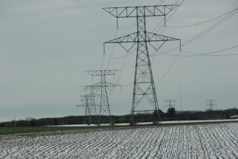 Under grey skies on the flat land north of Monticello, snow dusts fields.