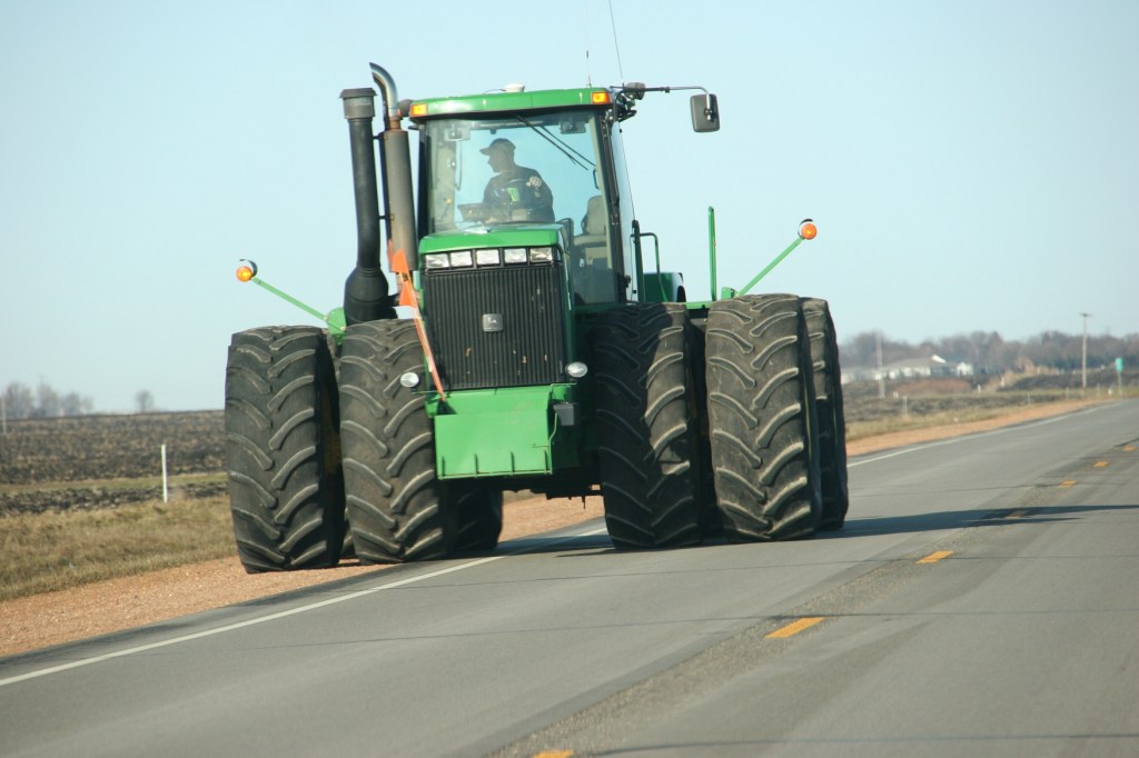 A farmer guides his John Deere tractor along Minnesota State Highway 67 near Morgan.