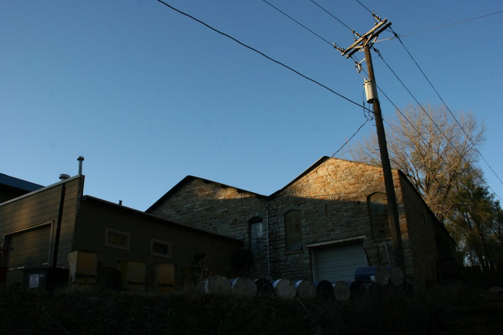 trail-4-side-of-limestone-building-with-barrels