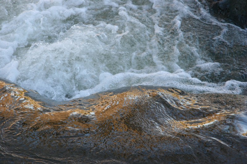 A close-up of the churning Straight River as photographed from the Morehouse Park recreational trail bridge.