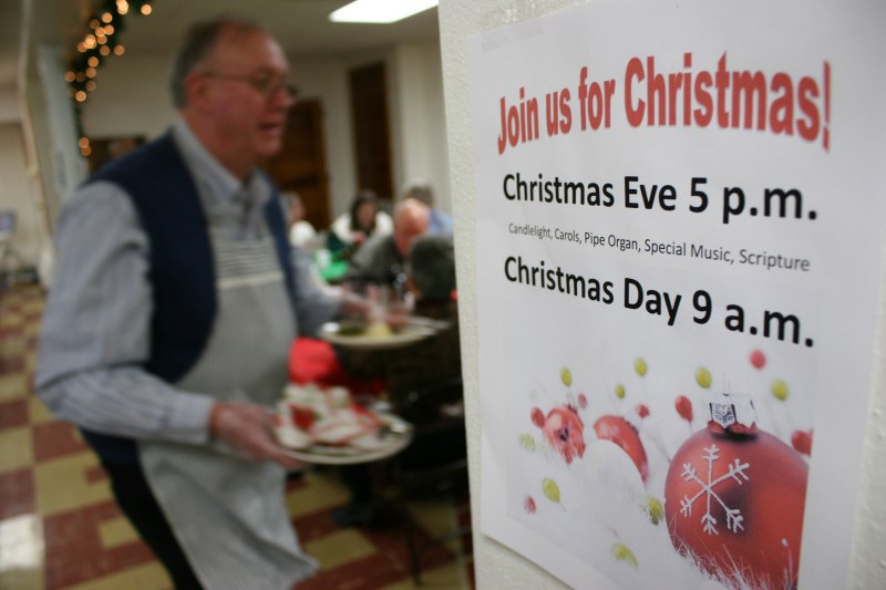 Signs posted throughout the basement welcome guests to Christmas worship services.