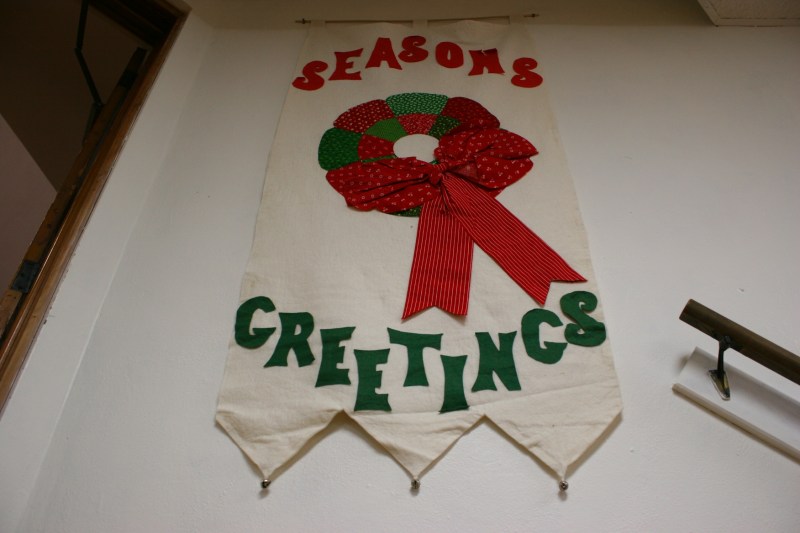 Holiday banners hang from basement walls.