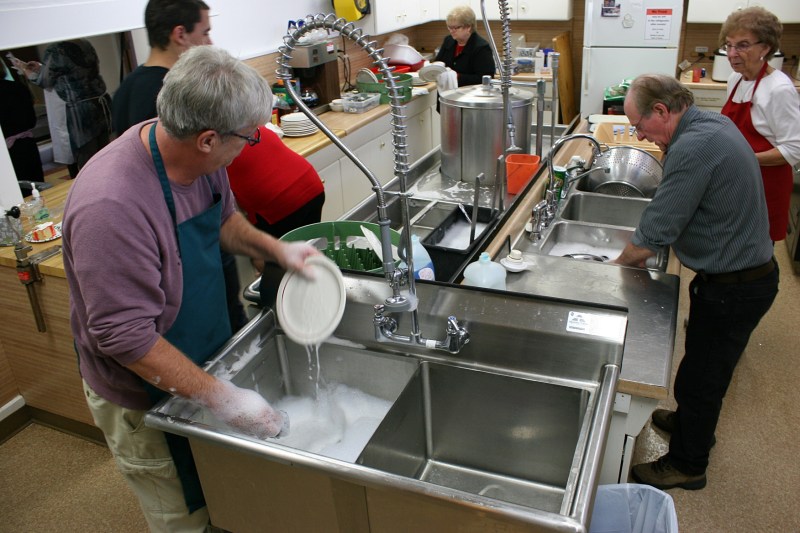 Behind the scenes, volunteers are busy washing dishes.
