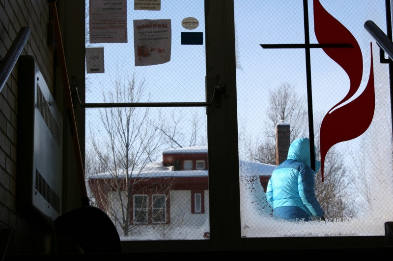 Despite temperatures in the double digits below zero, people braved the cold to attend the Community Christmas Dinner. Here a diner leaves the church.