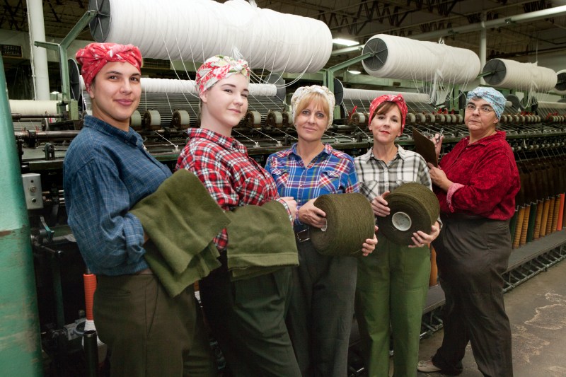 Some of the cast members of "Wrapped in Love & Glory" pose inside the Faribault Woolen Mill. Photo by Edward Brown.