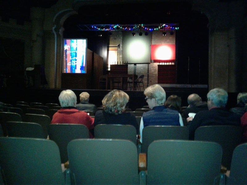 Before the play opened, I took this cell phone image of the set showing Woolen Mill blankets suspended with the video screen to the left.