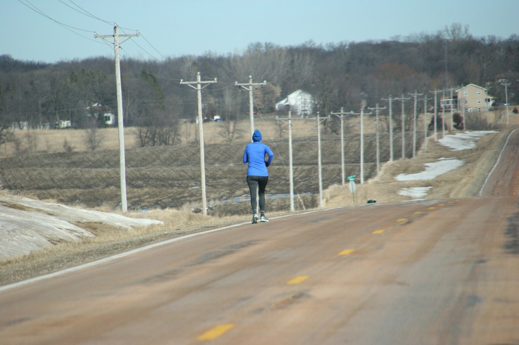 Runners ran along city streets and sidewalks and along rural roads in ideal weather conditions, here along Rice County Road 46.