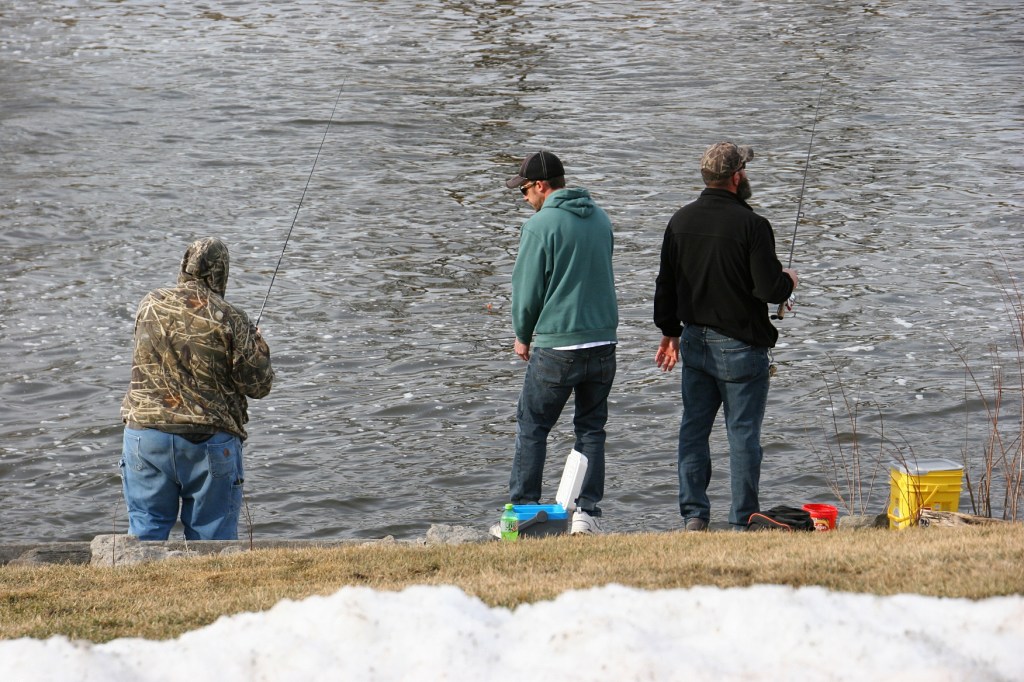 Minnesotans fished, here Sunday afternoon from the banks of the Cannon River by the woolen mill dam in Faribault. Snow pushed from the parking lot edged the river bank.