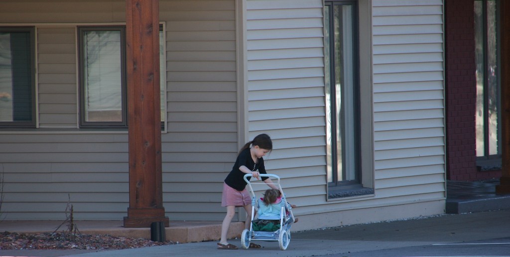 Families were out and about everywhere, including this little girl with her baby doll in downtown Jordan.