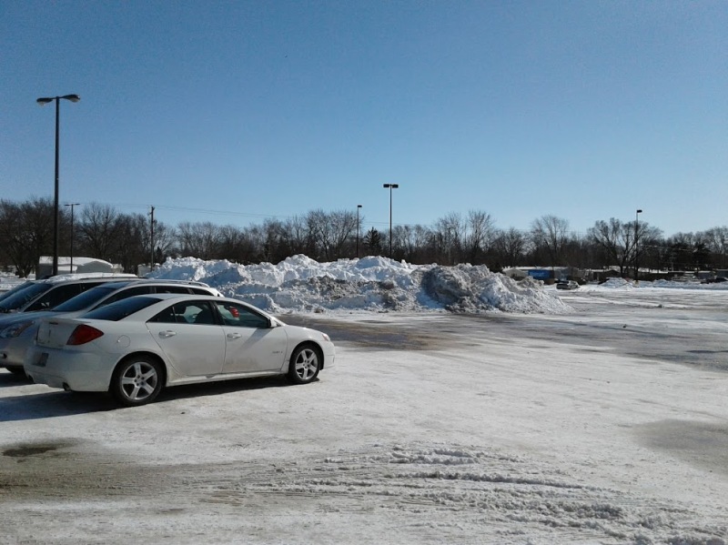 Snow from the Walmart and mall parking lot if pushed into mini mountains.