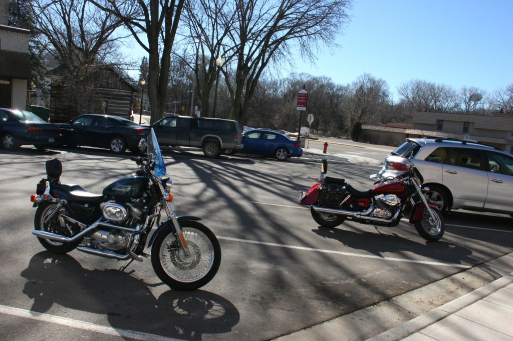 Two historic log cabins are situated downtown where bikers and others stopped on Saturday afternoon.
