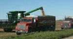 Harvest, #48 JD combine unloading corn into grain truck